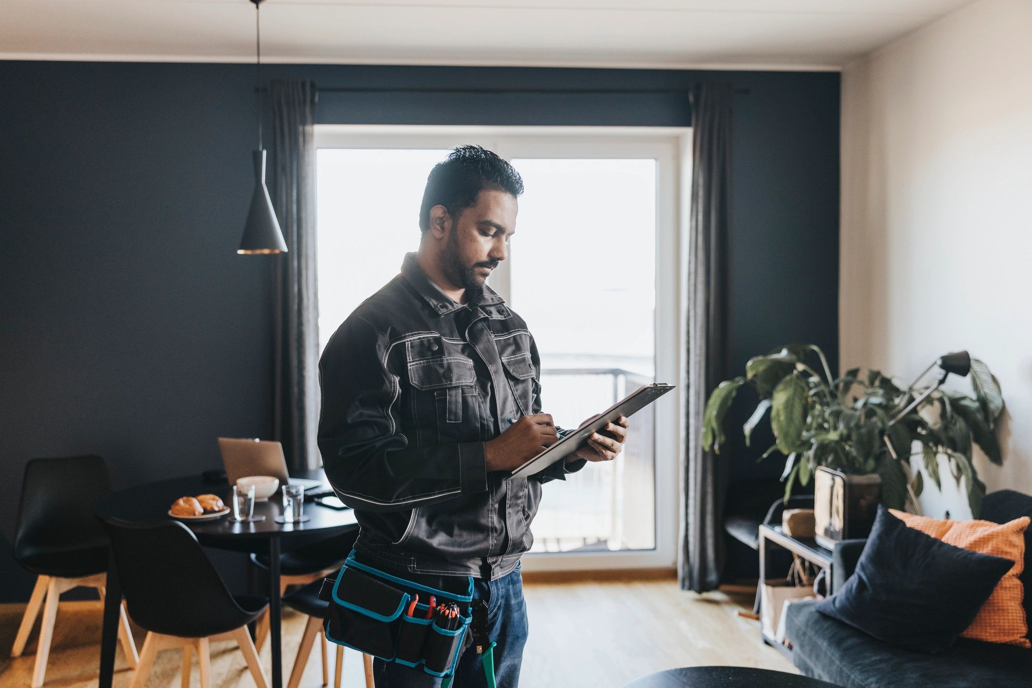 Maintenance technician reviewing tasks in an apartment