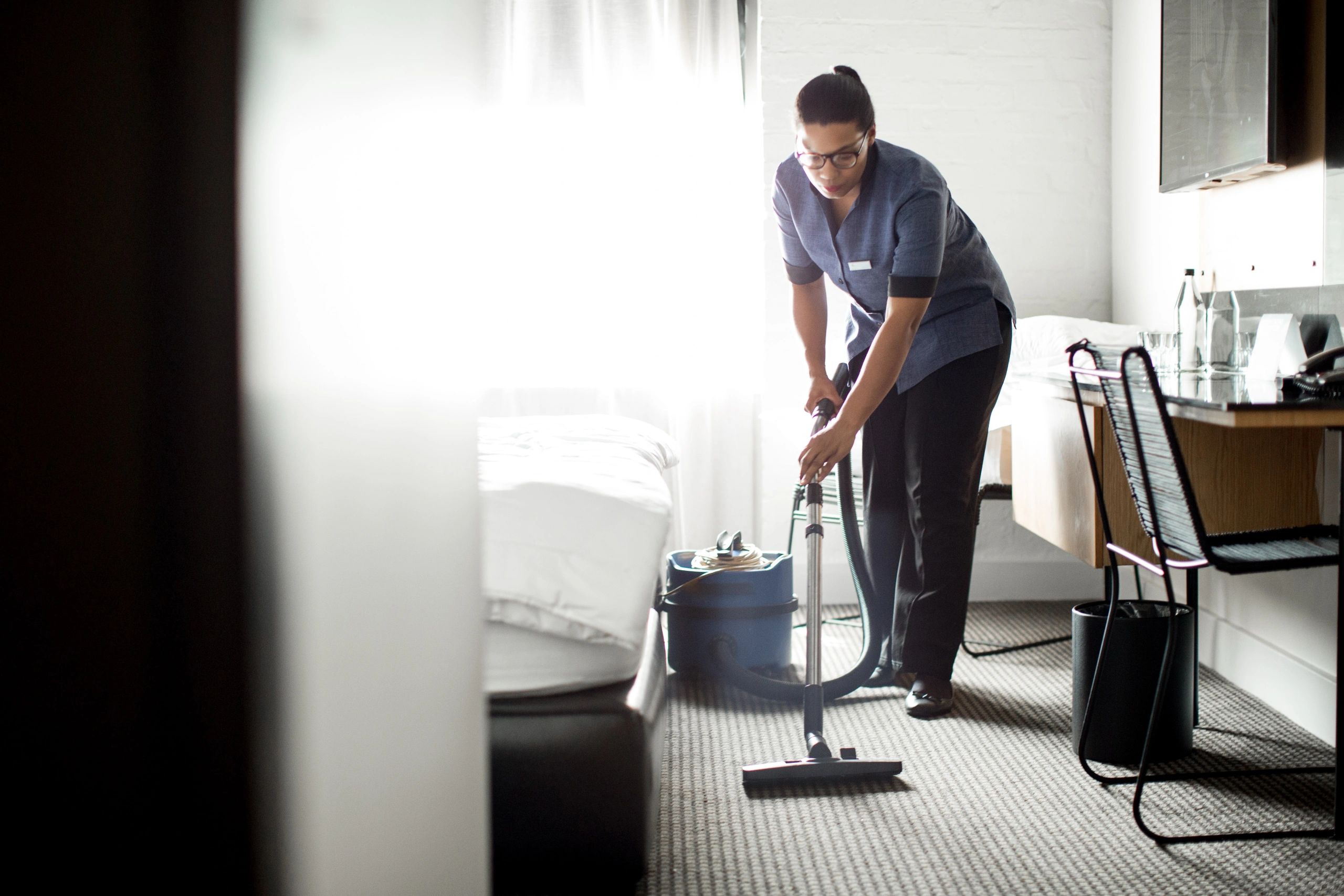 Cleaning professional preparing a room for guests